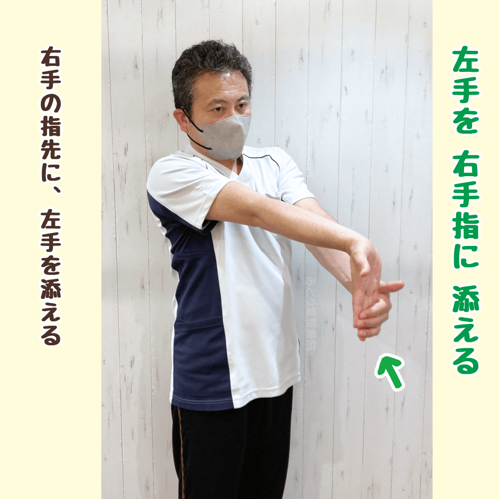 右手の指先に左手を添えて、ストレッチのポジションを取る（前腕屈筋群ストレッチ）